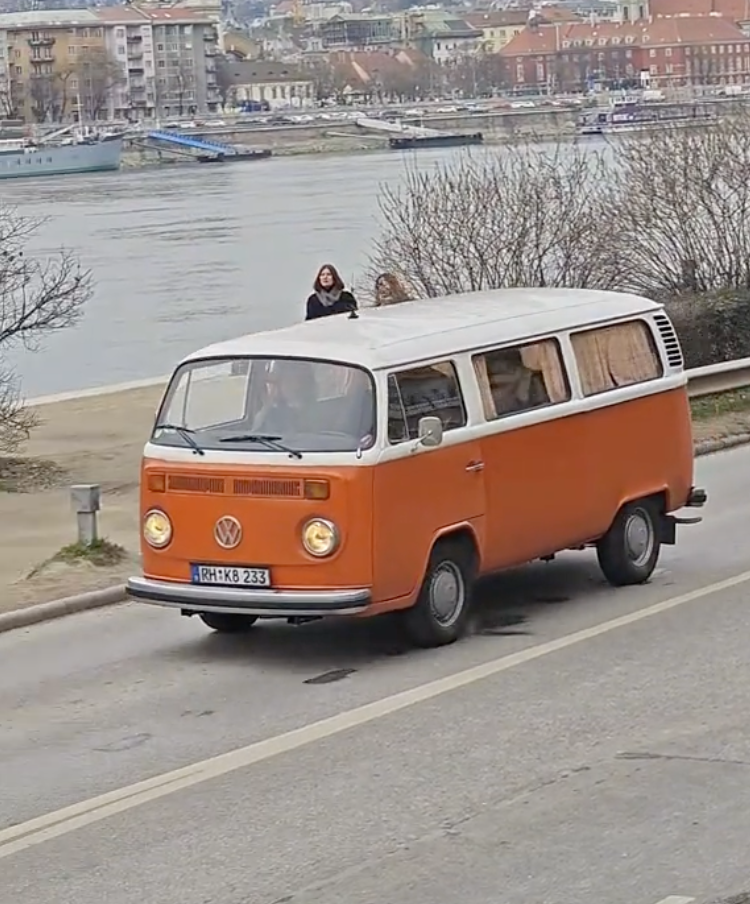 John Cena driving the orange VW T2 along the Danube in Budapest