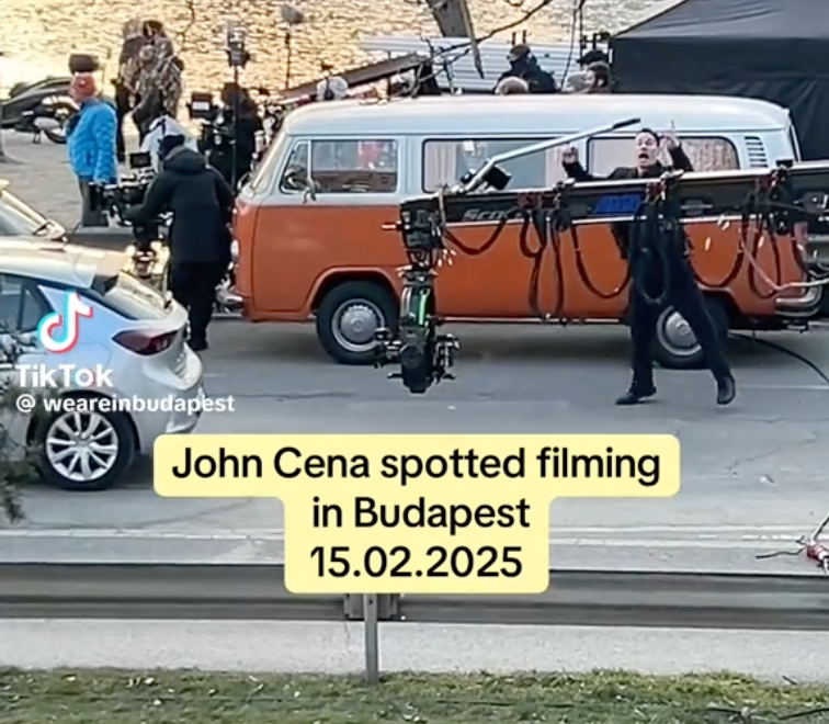 The orange VW T2 with John Cena and a camera rig on the Budapest riverside set, 15 February 2025
