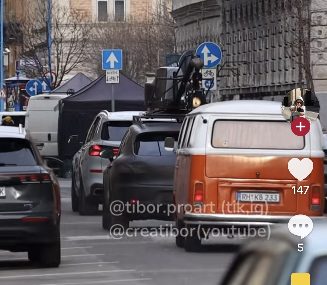 Rear view of the orange VW T2 with a camera rig on its roof in Budapest traffic
