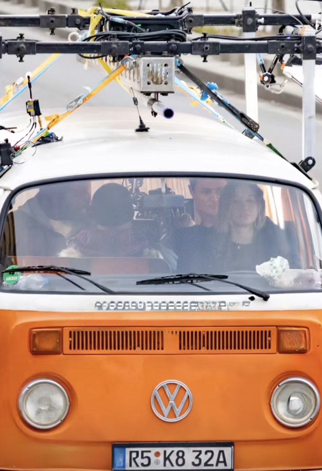 Front view of the orange VW T2 loaded with camera rigs, Jessica Biel visible through the windscreen